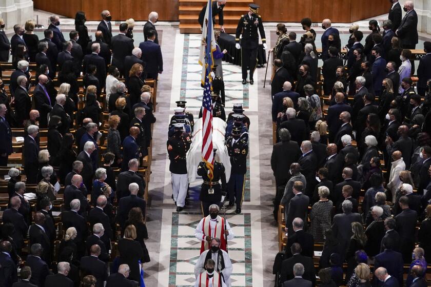 A military bearer team carries the casket after the funeral for former Secretary of State Colin Powell at the Washington National Cathedral, in Washington, Friday, Nov. 5, 2021. (AP Photo/Andrew Harnik)