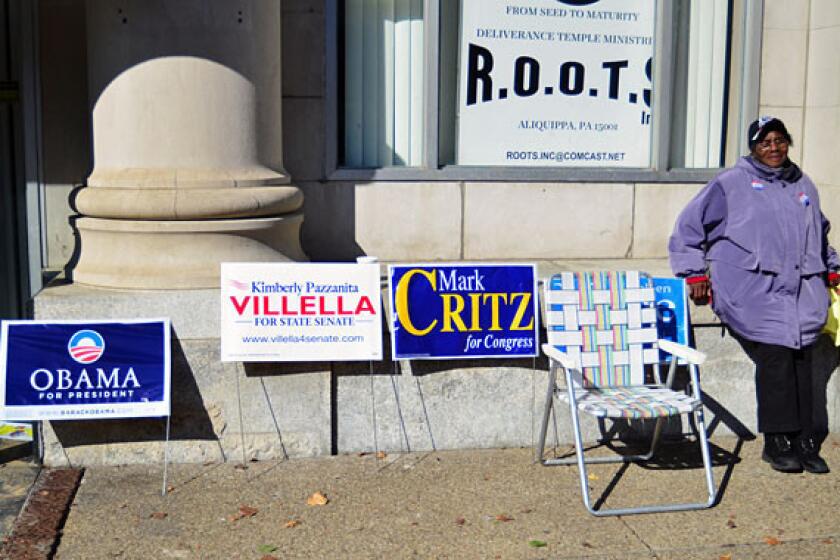 Poll worker Ruby Slappy waits to talk to voters outside of the Renaissance Center on Franklin Avenue in Aliquippa, Pa.