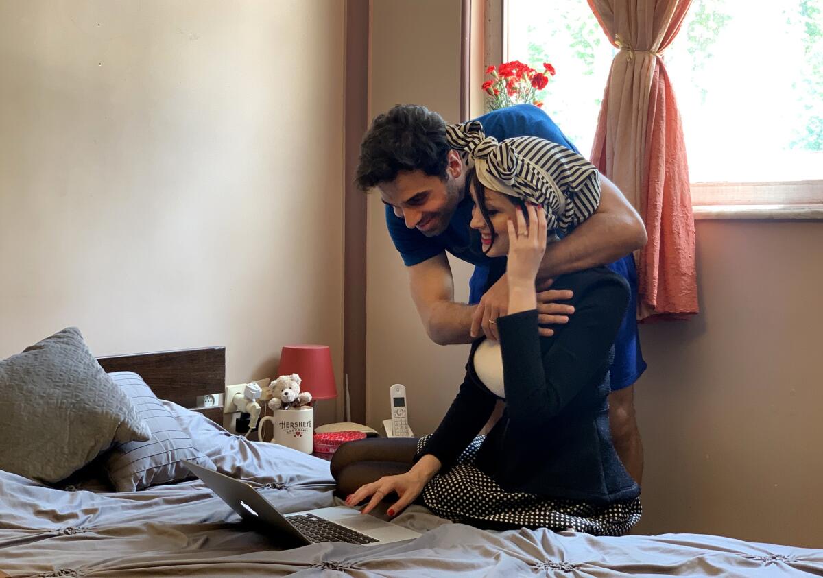Amin Sirati hugs wife Shamim Darchini at his home in Rasht, Iran. The years apart have been difficult for the couple. Darchini, a U.S. citizen, says she suffers from anxiety because of the uncertainty of whether her husband's visa will be approved.