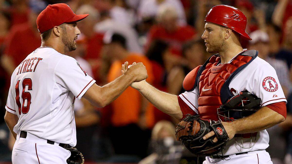 Angels closer Huston Street is congratulated by catcher Chris Iannetta following the team's 3-2 win over the Baltimore Orioles.