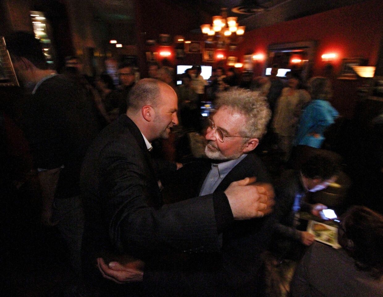 L.A. Unified District 4 candidate Steve Zimmer, left, hugs supporter Kenneth Urbina, principal of Gardner Street Elementary, as he arrives at an election-night party in Los Angeles.