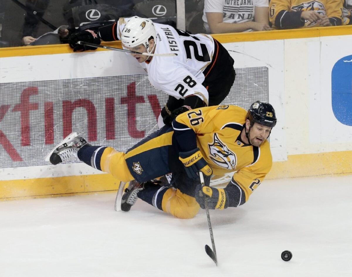 Ducks defenseman Mark Fistric (28) battles Nashville Predators forward Matt Hendricks for the puck during a game Jan. 9.