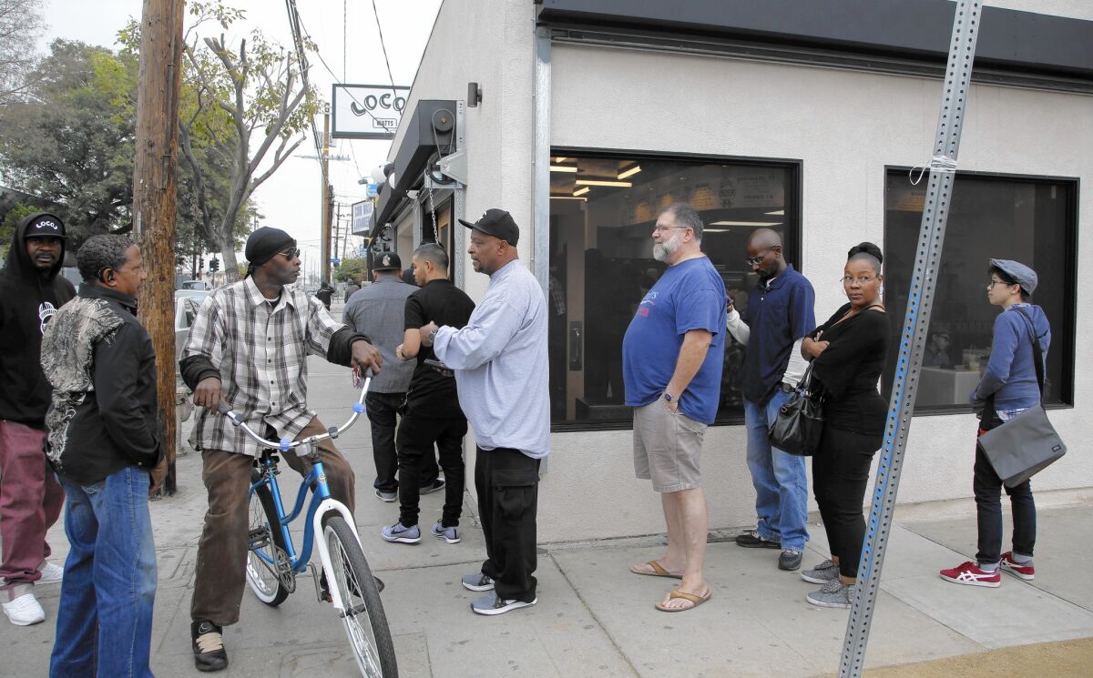 Patrons line up outside Locol on Tuesday, its second day of business. The "energy of Watts, this specific neighborhood, is on the block," chef Roy Choi says.