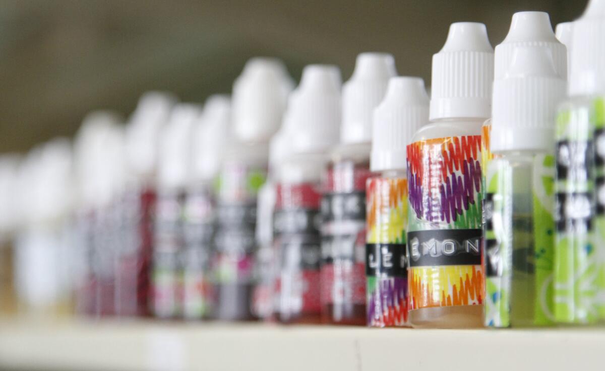 Various flavors of liquid nicotine for e-cigarettes are displayed at an e-cigarette store in Tennessee.