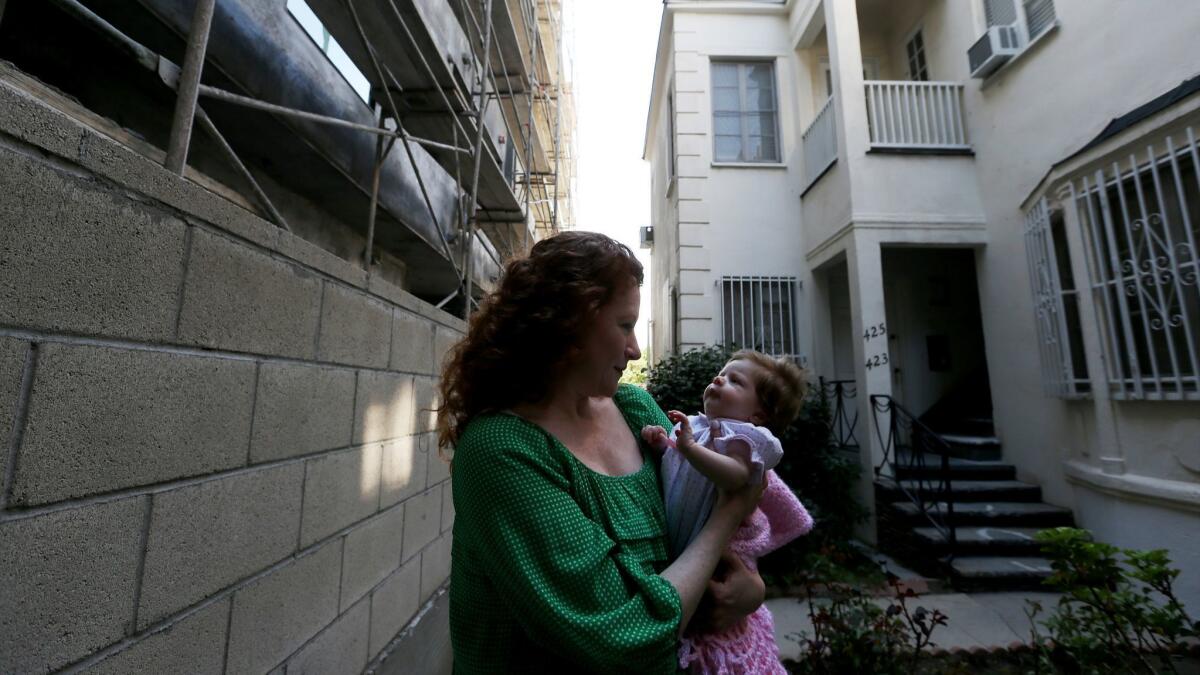 A woman and her daughter live in an apartment building that was purchased by a company that's evicted more than 300 tenants over the past decade in Los Angeles, Calif. on Feb. 23, 2016.