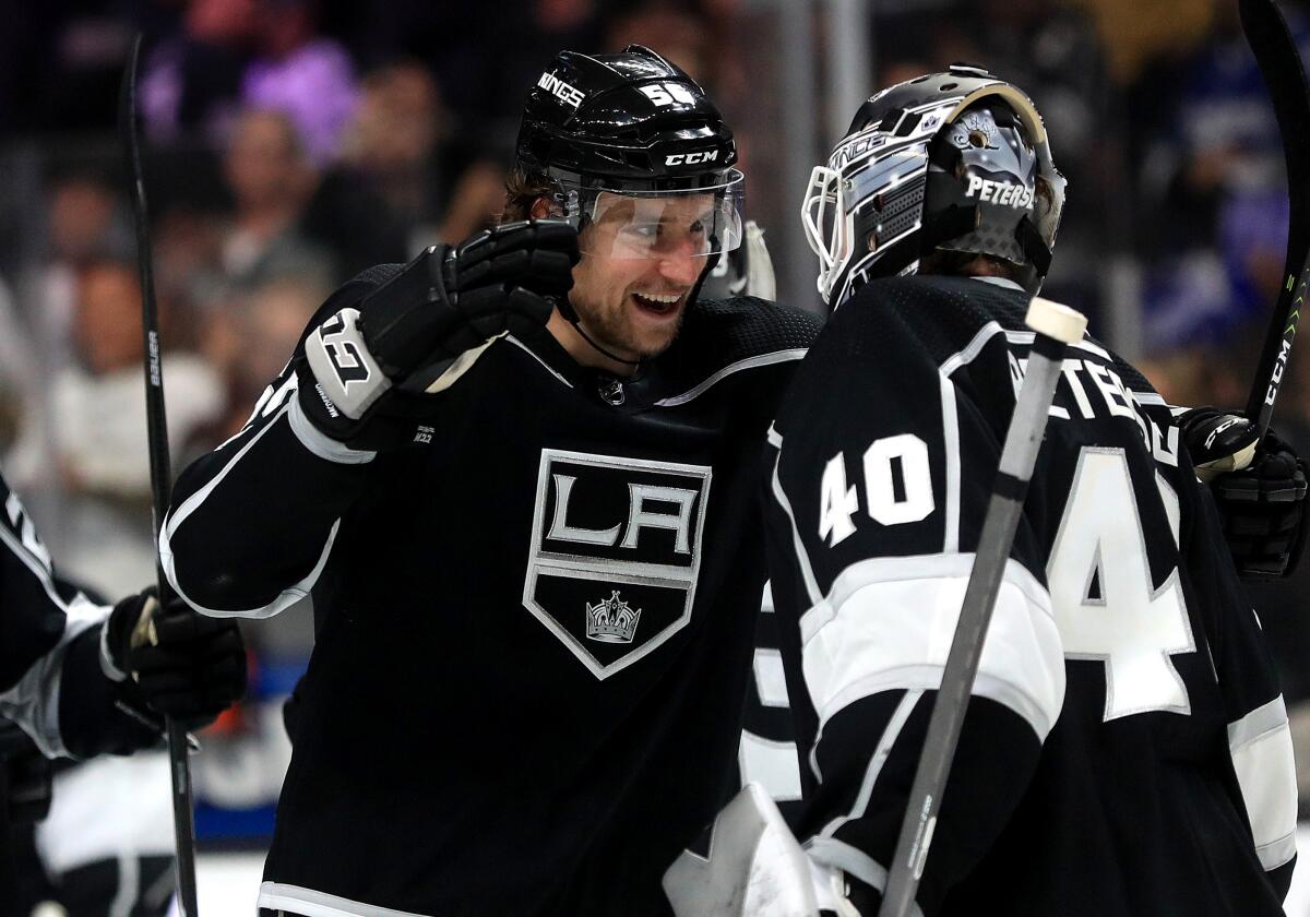 Kings defenseman Kurtis MacDermid celebrates with teammate Cal Petersen following a win over the Calgary Flames at Staples Center on Feb. 12.