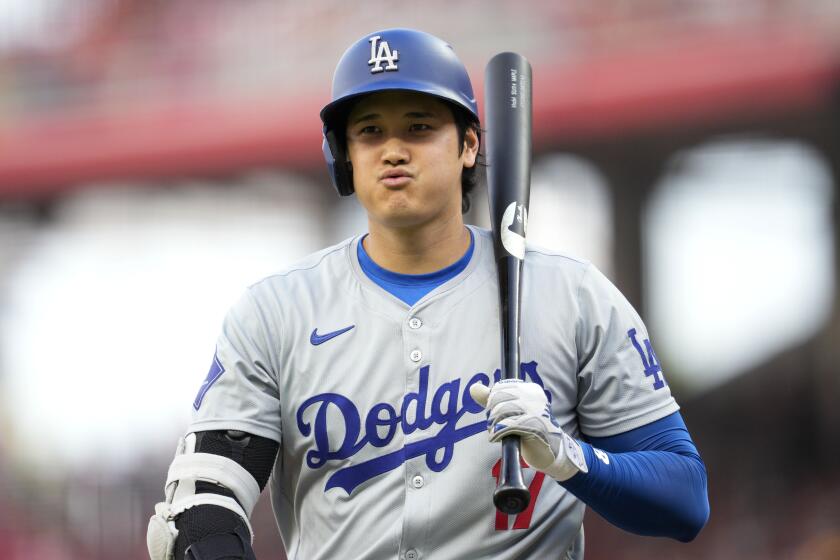 Los Angeles Dodgers' Shohei Ohtani reacts after striking out during the first inning.