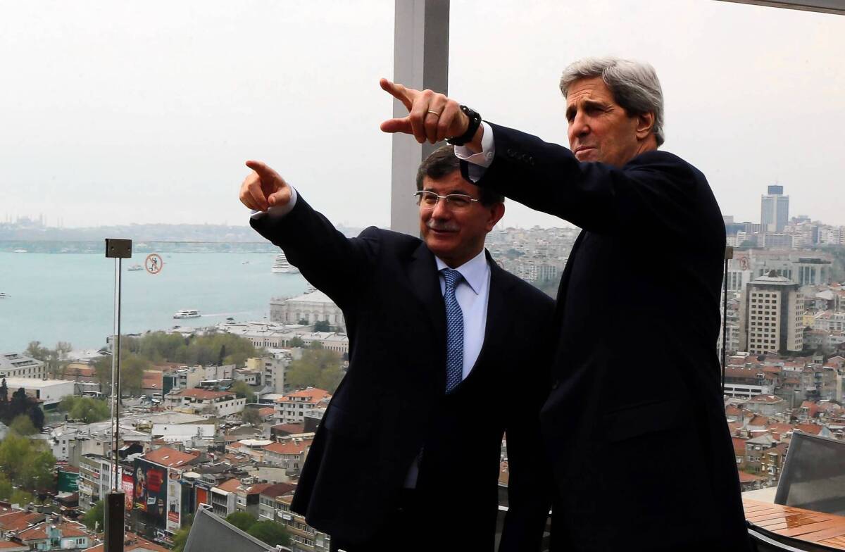 Turkish Foreign Minister Ahmet Davutoglu shows U.S. Secretary of State John F. Kerry the skyline of Istanbul before the start of a meeting in the Turkish city.
