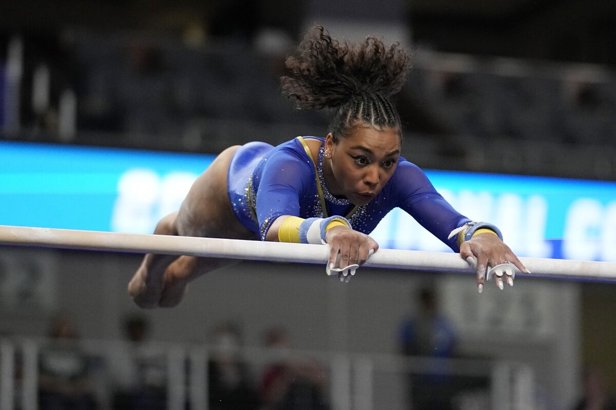 UCLA's Margzetta Frazier competes on the uneven bars during the NCAA gymnastics championship semifinals.