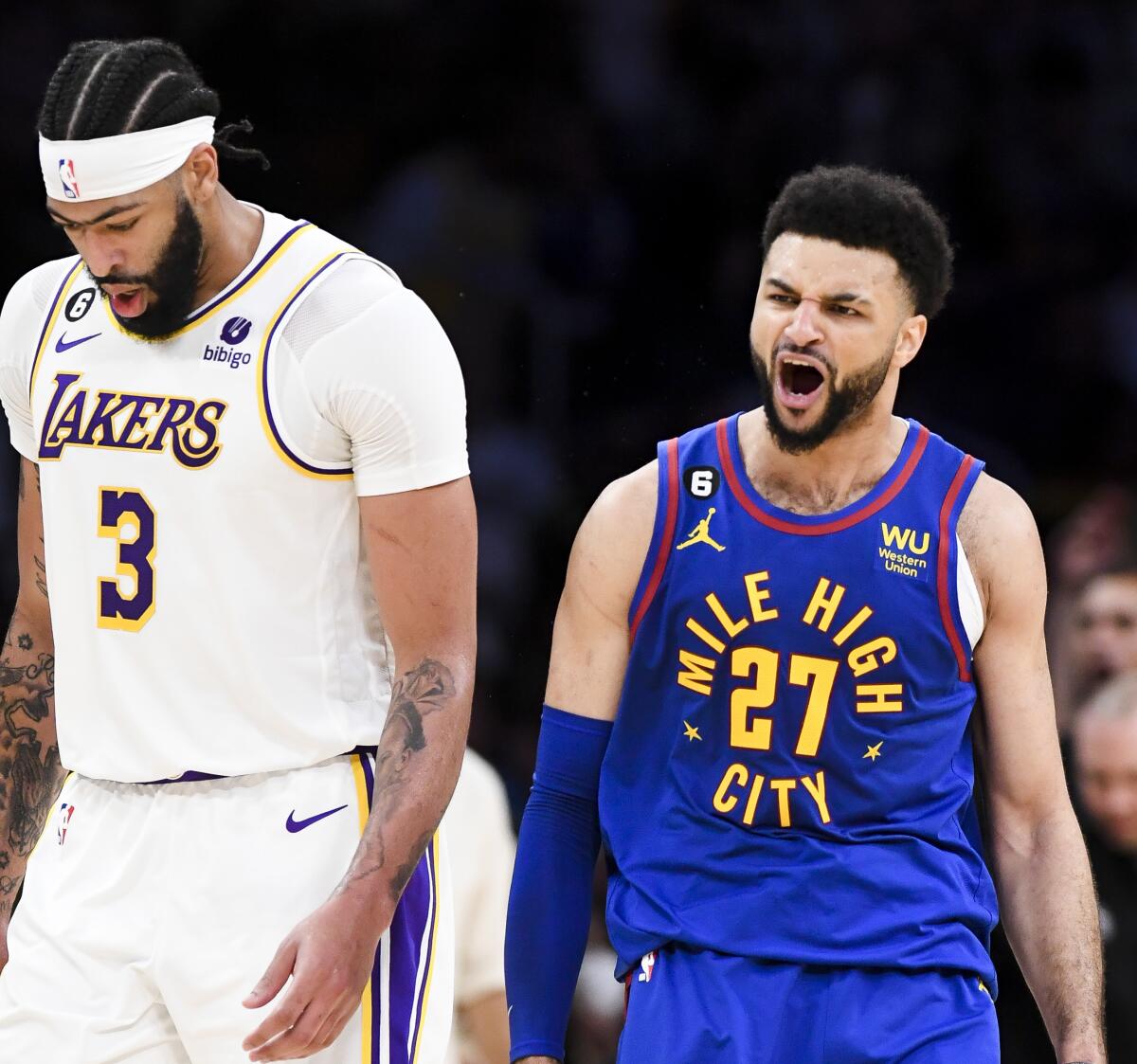 Nuggets guard Jamal Murray, right, celebrates after making a three-pointer against Anthony Davis and the Lakers in Game 3.