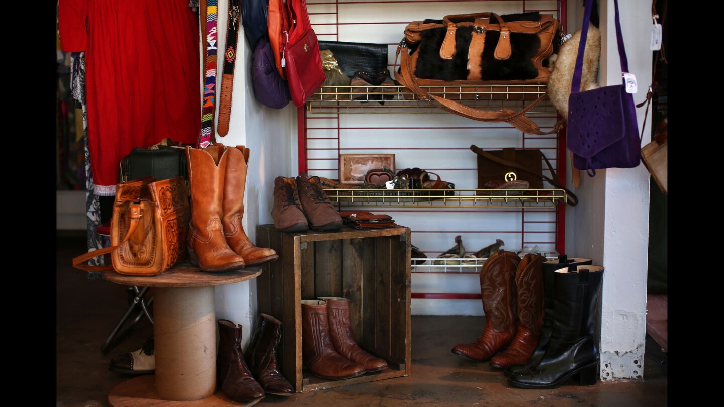 Leather accessories, including a hand-tooled purses, cowboy boots, belts and wallets are among the items at Far Outfit on East 4th Street in Long Beach.