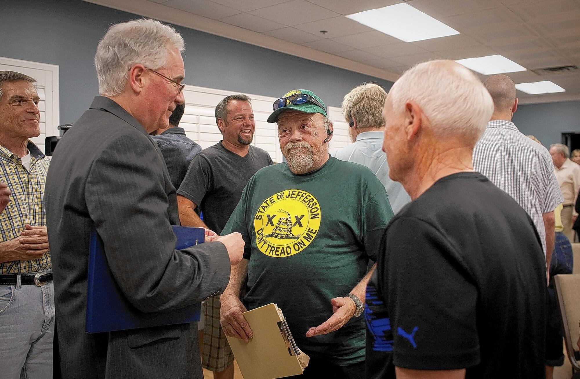 Rep. Tom McClintock, left, talks with voters after speaking to a tea tarty group in Rocklin, Calif.