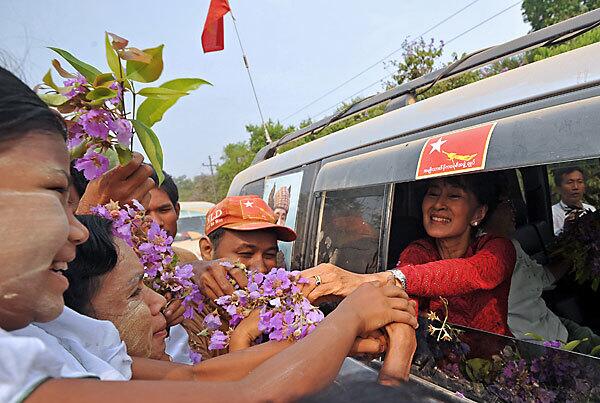 Myanmar opposition leader Aung San Suu Kyi greets supporters