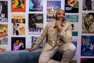 Universal City, CA - August 22: Justin Simien sits for portraits at his office on Thursday, Aug. 22, 2024 in Universal City, CA. Simien, best known for his 2014 breakthrough film "Dear White People," has a new documentary series "Hollywood Black," looking at the turbulent history of Black film and filmmakers. (Brian van der Brug / Los Angeles Times)