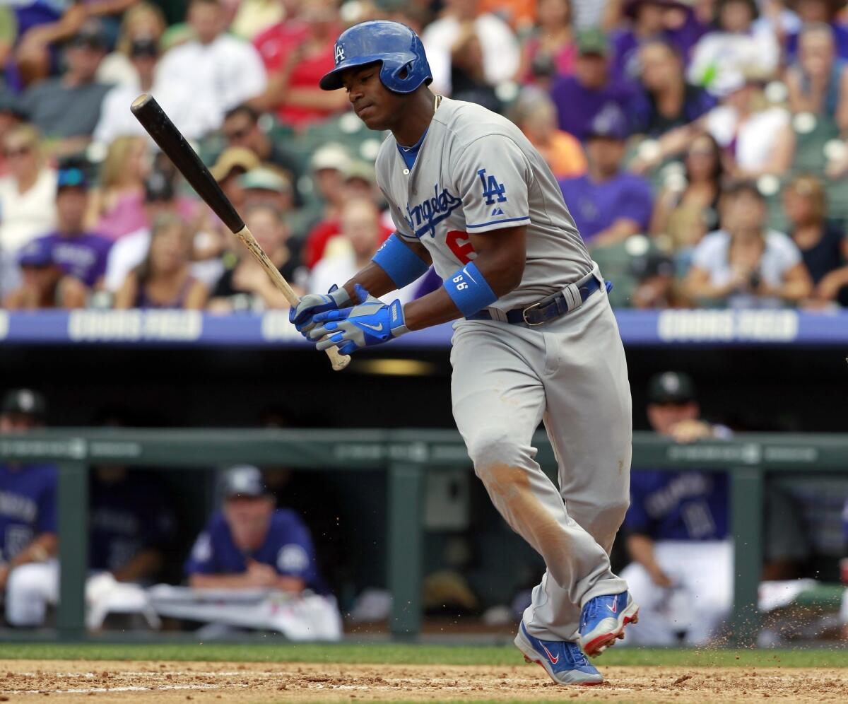 Dodgers right fielder Yasiel Puig spins in the batter's box after being hit by a pitch during the fourth inning of Monday's game against the Colorado Rockies. Puig left the game in the fifth inning with what appeared to be a knee injury.