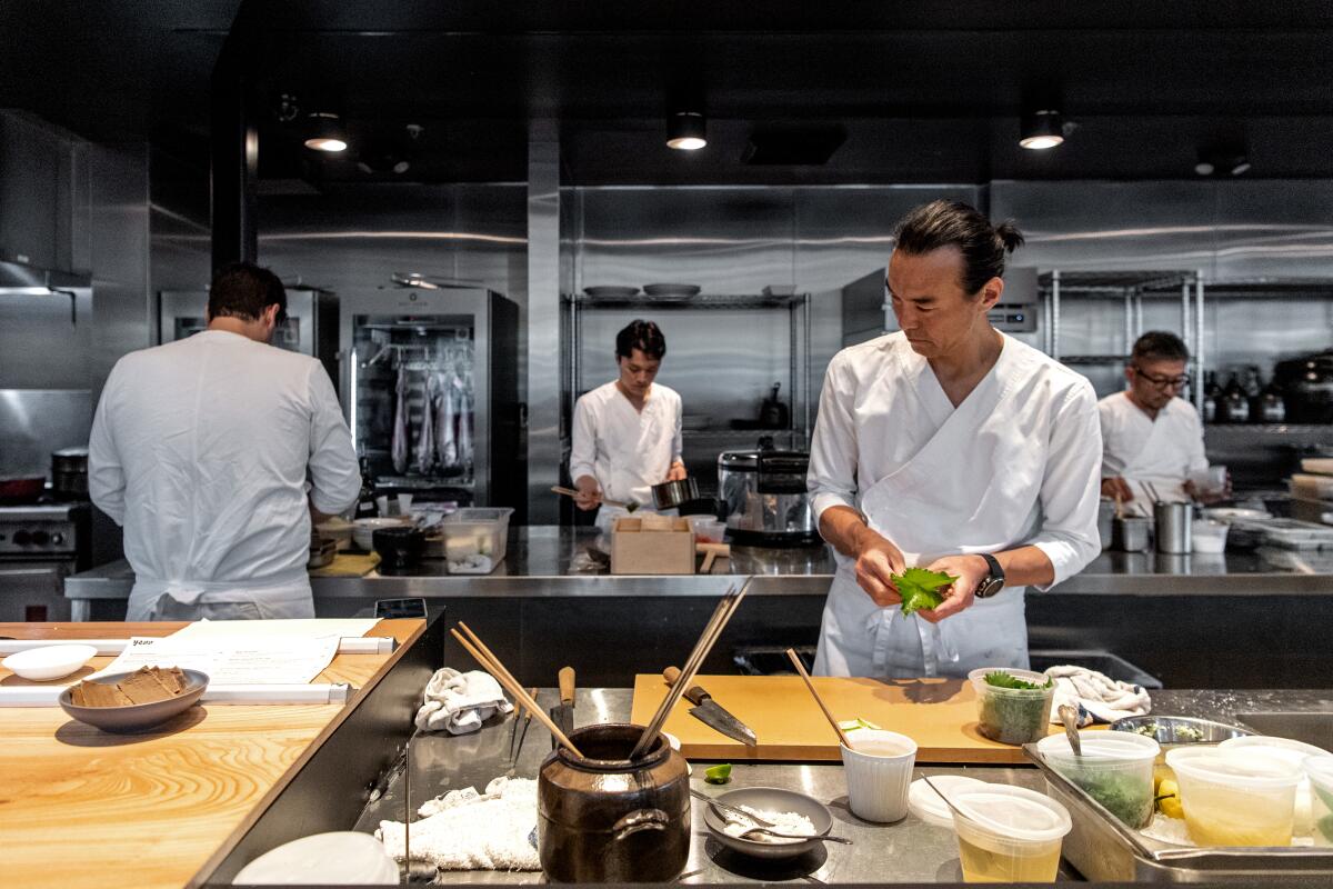 Chef Junya Yamasak prepares dishes inside the large open kitchen of Yess restaurant