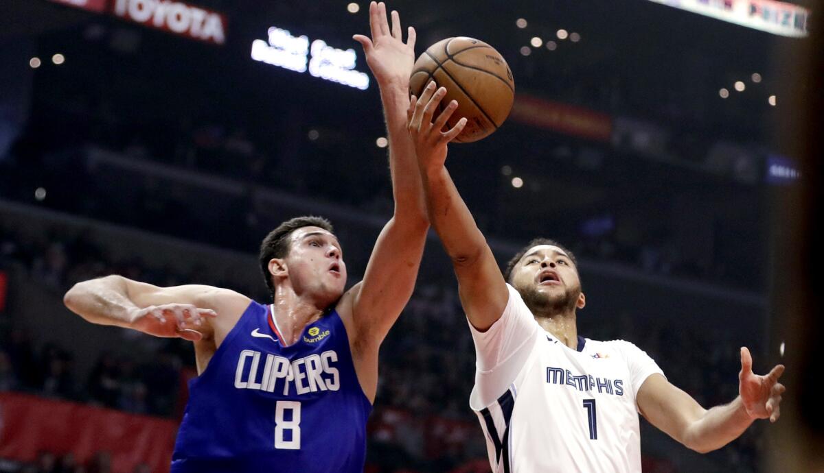 Clippers forward Danilo Gallinari prepare to block a shot by Grizzlies forward Kyle Anderson during the first half Friday.
