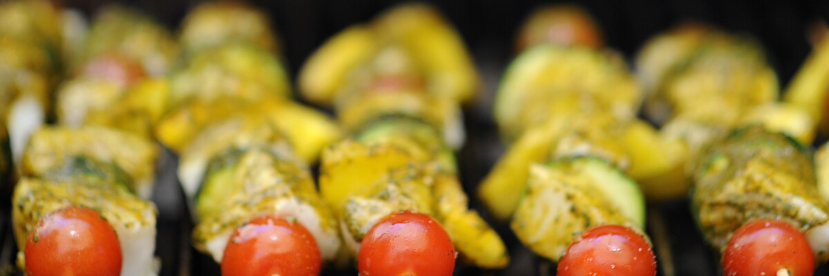 Sea bass kabobs brushed with Chermoula sauce on the grill 