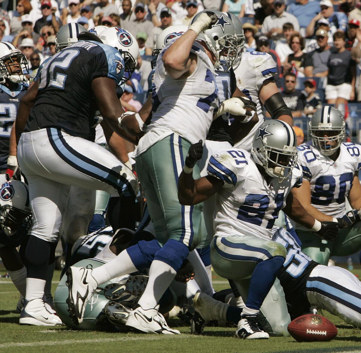 Tennessee Titans defensive tackle Albert Haynesworth, left. stomps the face of Dallas Cowboys center Andre Gurode on Oct. 1, 2006. (AP Photo/John Russell, File)