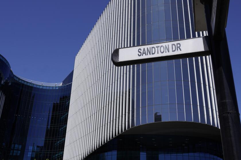 This photo taken Tuesday, Oct. 1, 2024, shows a sign on Sandton Drive in Johannesburg's financial district of Sandton, the road at the center of a controversy after city officials proposed renaming it after a Palestinian militant who was involved in hijacking two planes more than 50 years ago. (AP Photo/Denis Farrell)