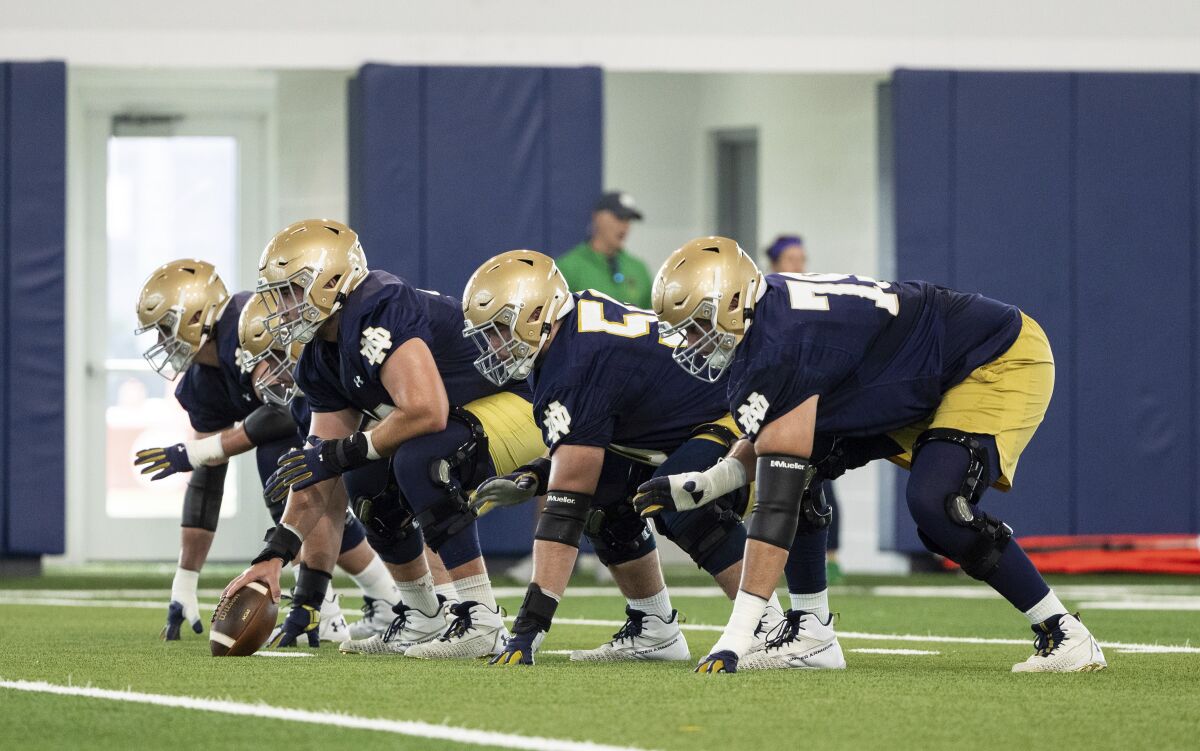 Notre Dame offensive lineman in three point stance during Notre Dame Fall Camp on Saturday, Aug. 7, 2021, at Irish Athletics Center in South Bend, Ind. (John Mersits/South Bend Tribune via AP)
