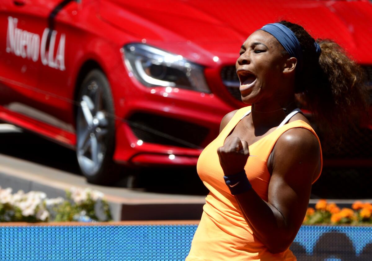 Serena Williams celebrates a point against Maria Sharapova during their women's singles final match at the Madrid Masters.