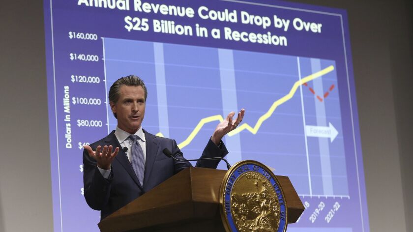 Gov. Gavin Newsom presents his first state budget on Jan. 10 in Sacramento. The plan includes a legally untested view of how to treat extra payments into California's rainy-day fund.
