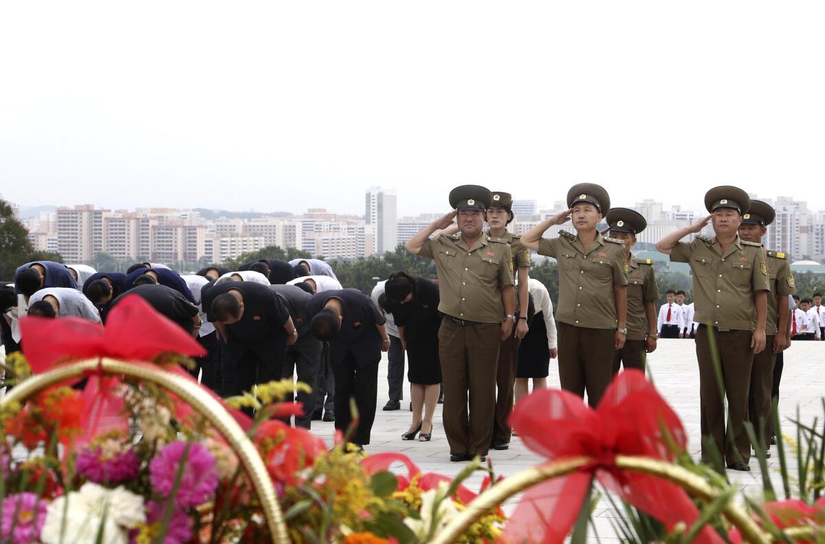 Pyongyang residents paying tribute to statues of late leaders