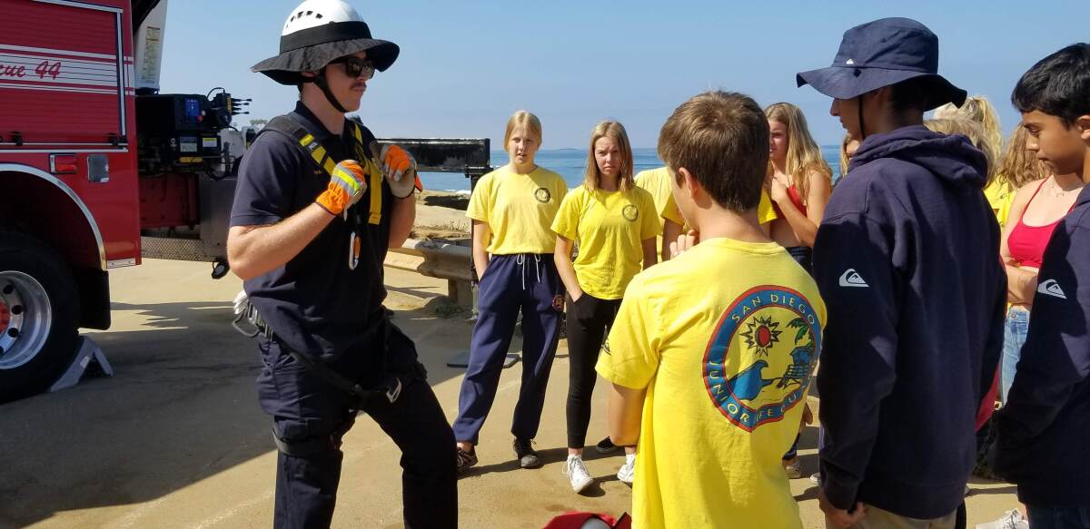 This group learns how to strap on a harness for descending and ascending cliffs.