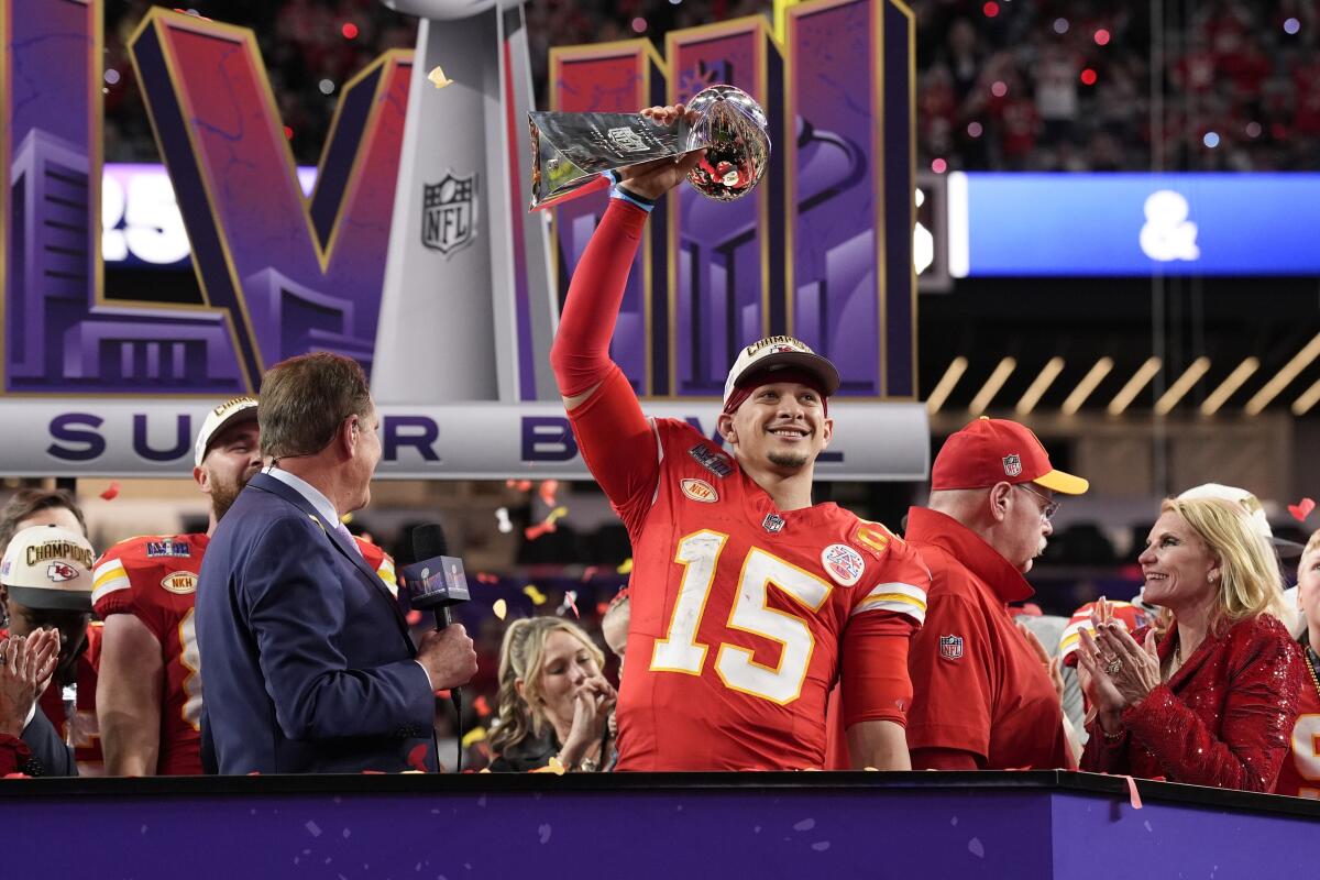 Chiefs quarterback Patrick Mahomes (15) holds the Vince Lombardi Trophy after winning Super Bowl LVIII and the MVP award.