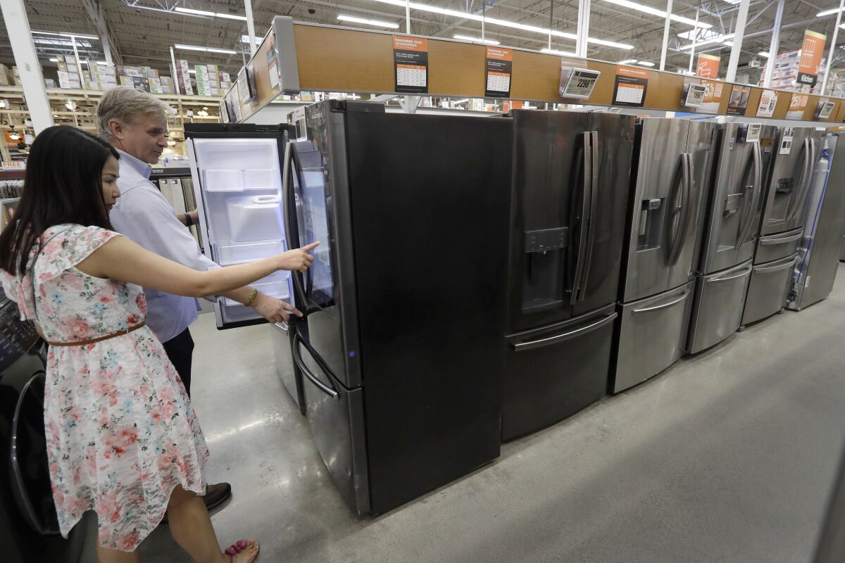 Shoppers examine refrigerators at a Home Depot store in Boston on Sept. 23.
