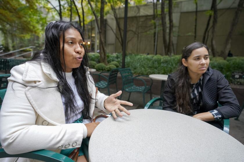 Venezuelans Yeysy Hernandez, left, and Candy Cegarra speak during an interview with The Associated Press, Thursday, Oct. 13, 2022, in New York. (AP Photo/Mary Altaffer)
