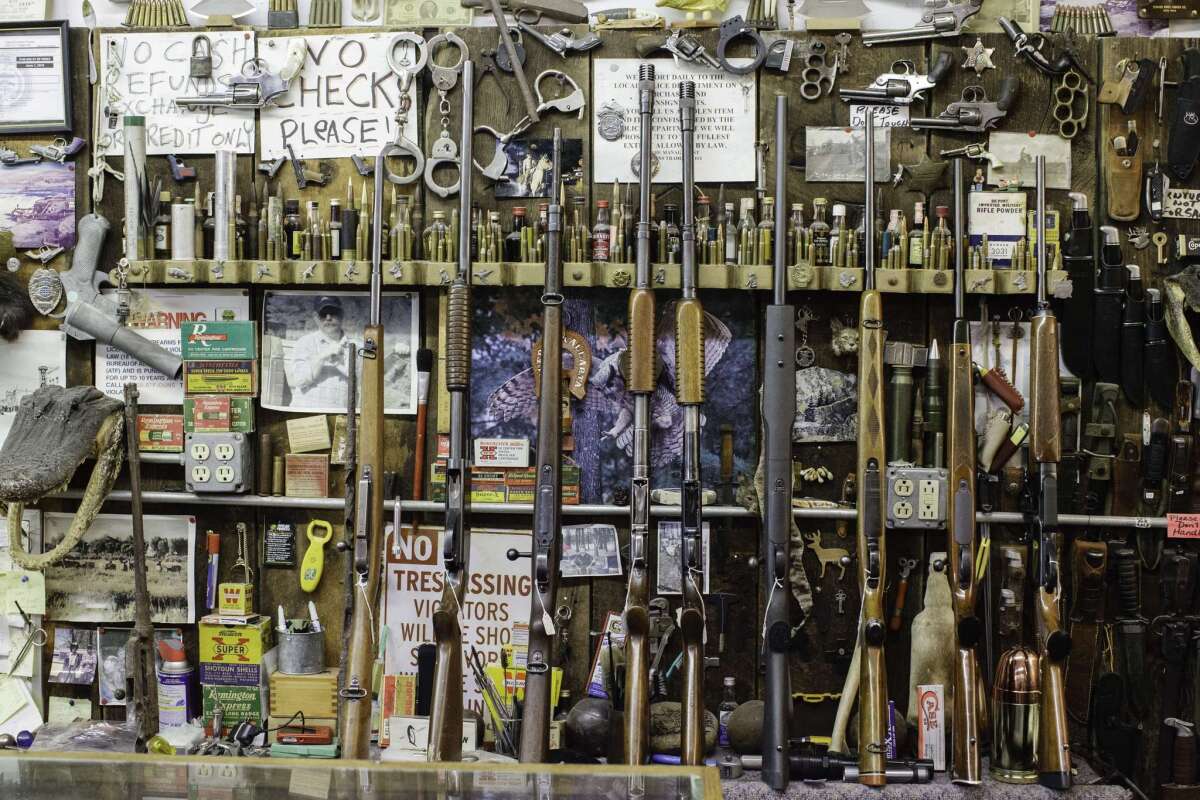 Used guns sit for sale in an elaborate western display at the Burns Trading Post in Burns, Ore.