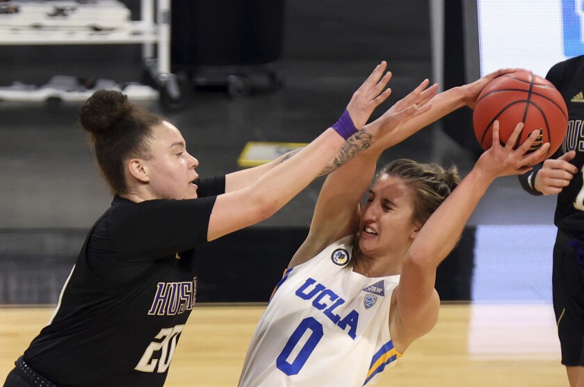 UCLA guard Chantel Horvat is defended by Washington forward Khayla Rooks.
