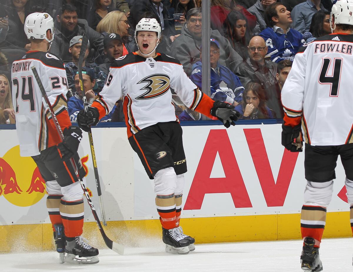 The Ducks' Max Jones, middle, celebrates his short-handed goal in the third period Feb. 7, 2020.