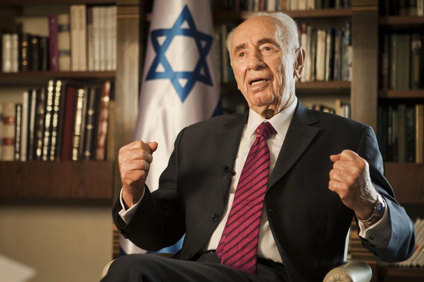 Then-Israeli President Shimon Peres gives an interview at his home in Jerusalem on July 15, 2014.