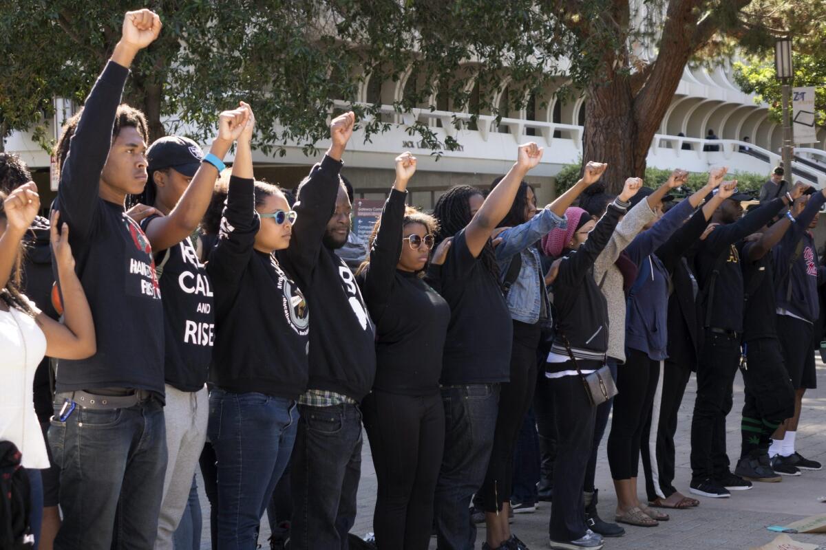 University of California, Irvine students raise their fists in solidarity with the University of Missouri demonstrations, in Irvine on November 12.
