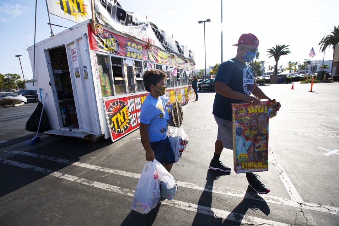 Jaden Veal, 7, and his father, James Veal, of Hawthorne purchase fireworks.
