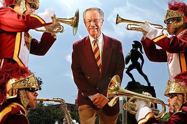 Dr. Arthur C. Bartner, director of the USC Marching band since 1970, is photographed with members of the unit next to the statue of Tommy Trojan on the USC campus on Aug. 12, 2011.