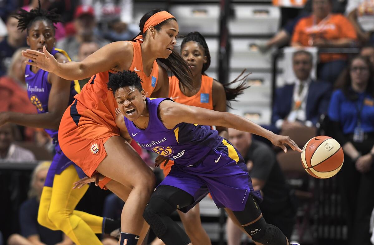 Connecticut's Brionna Jones, left, fouls Sparks guard Alana Beard.