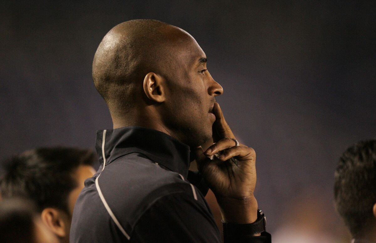 Kobe Bryant stands on the sidelines before the start of an international exhibition game between the United States and China at Qualcomm Stadium in San Diego on April 10.