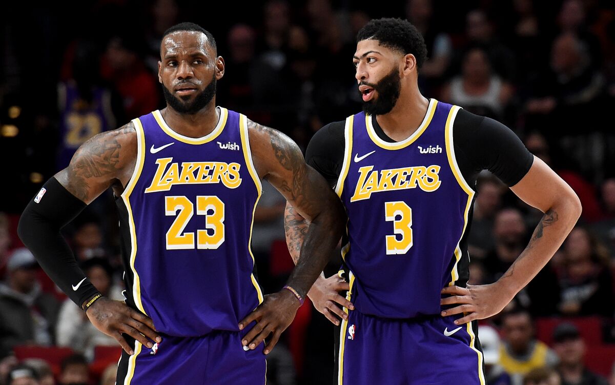 Lakers stars LeBron James and Anthony Davis stand on the court together.