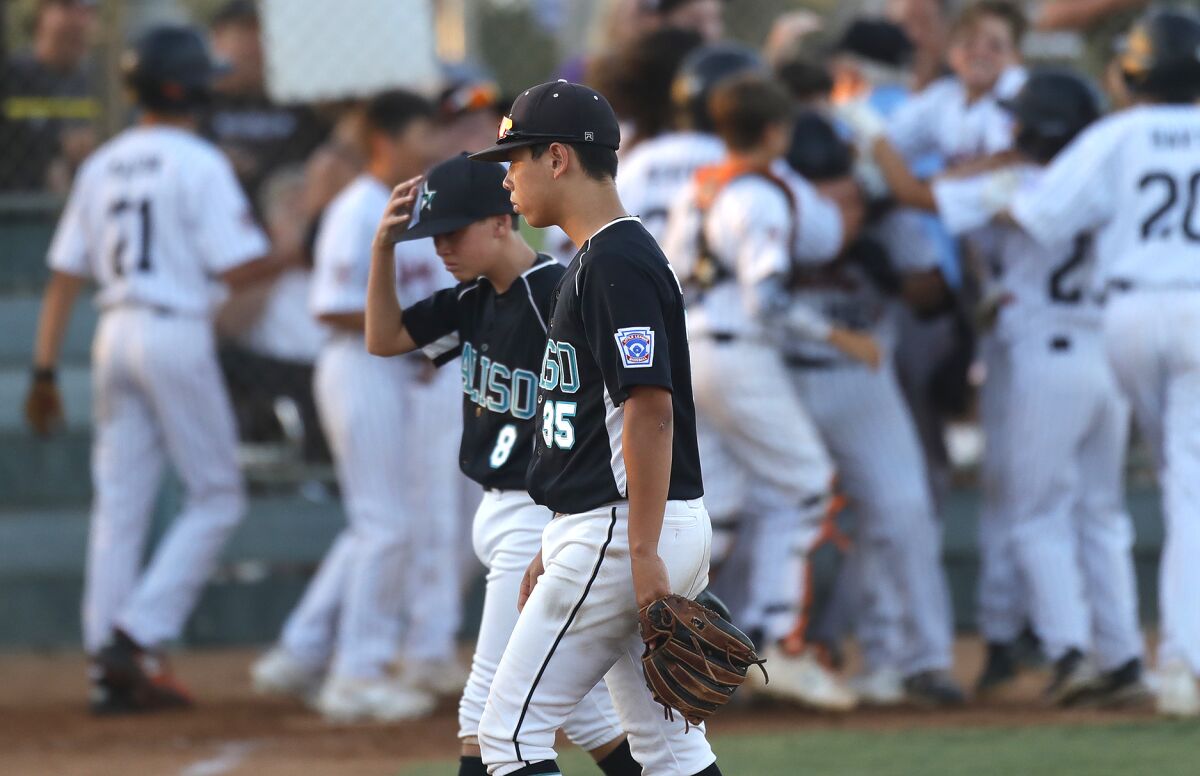 Aliso Viejo's Avery Bateman (8) and Dylan Bright (35) walk off the field after a walk-off home run by Huntington Valley.