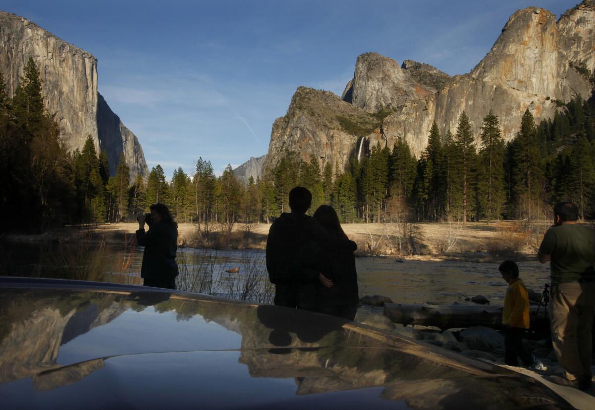 Visitors stop to look, photograph and enjoy the light and scenery of the Yosemite Valley on a cool spring evening.