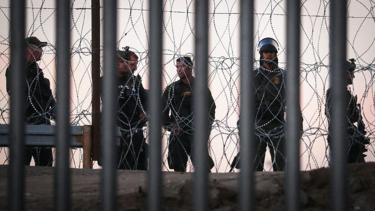 Border Patrol agents stand watch on the U.S. side of the border fence near Tijuana on Nov. 26, 2018.