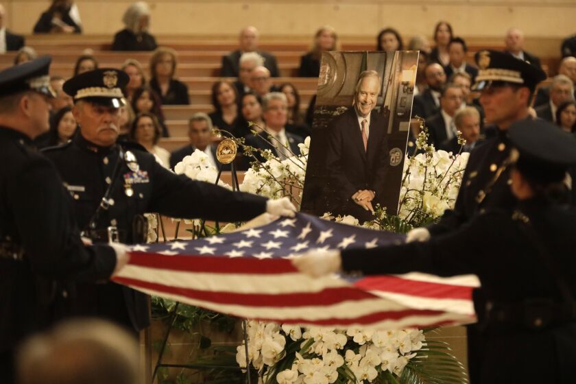 LOS ANGELES, CA - APRIL 28, 2023 - LAPD Color Guard conduct the Presentation of the Flag as a photo of former Los Angeles Mayor Richard Riordan looks on during a Memorial Mass in celebration of the fife of the former mayor at the Cathedral of Our Lady of the Angeles in downtown Los Angeles on April 28, 2023. Archbishop Jose H. Gomez presides over the Mass and the homily is delivered by Msgr. Lloyd Torgerson, pastor at St. Monica Catholic Church, which was Riordan's parish. Many dignitaries including Los Angeles Mayor Karen Bass and U.S. Senator Alex Padilla were in attendance. (Genaro Molina / Los Angeles Times)