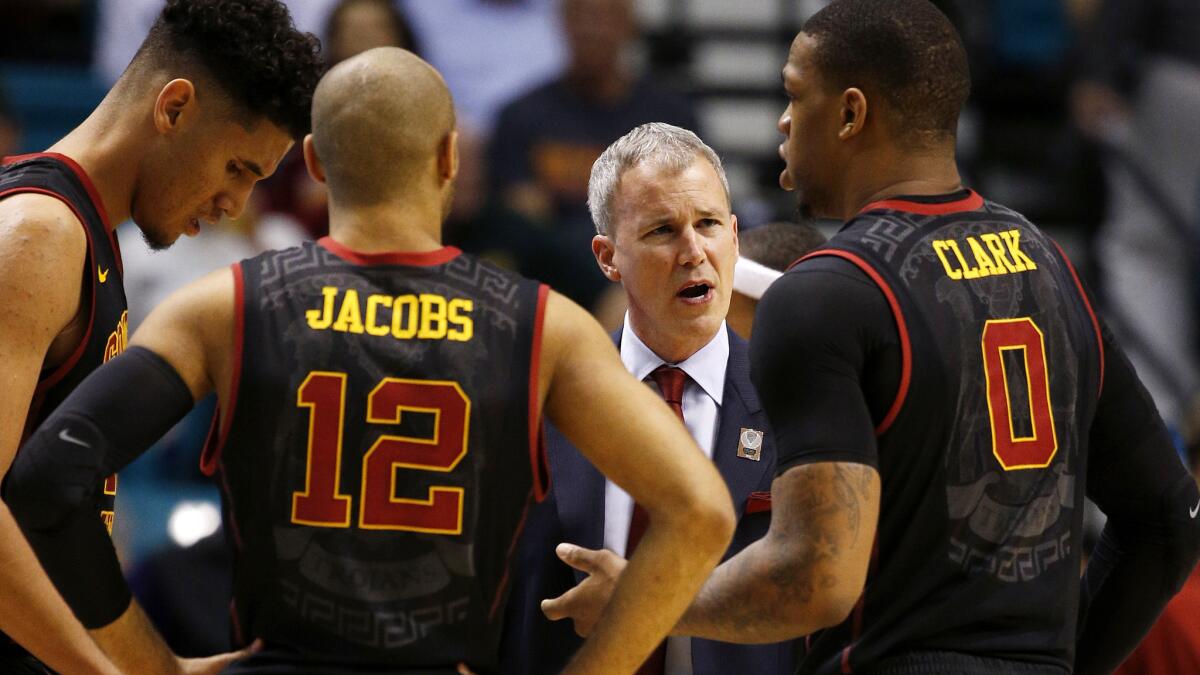 USC Coach Andy Enfield speaks with forward Bennie Boatwright, left, guard Julian Jacobs and forward Darion Clark during the second half of the Pac-12 tournament game Thursday.