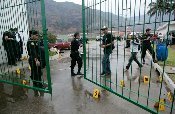 Police investigate the scene of an ambush of Guatemalan anti-drug agents in an industrial park in Amatitlan, about 20 miles from the nation's capital, Guatemala City.