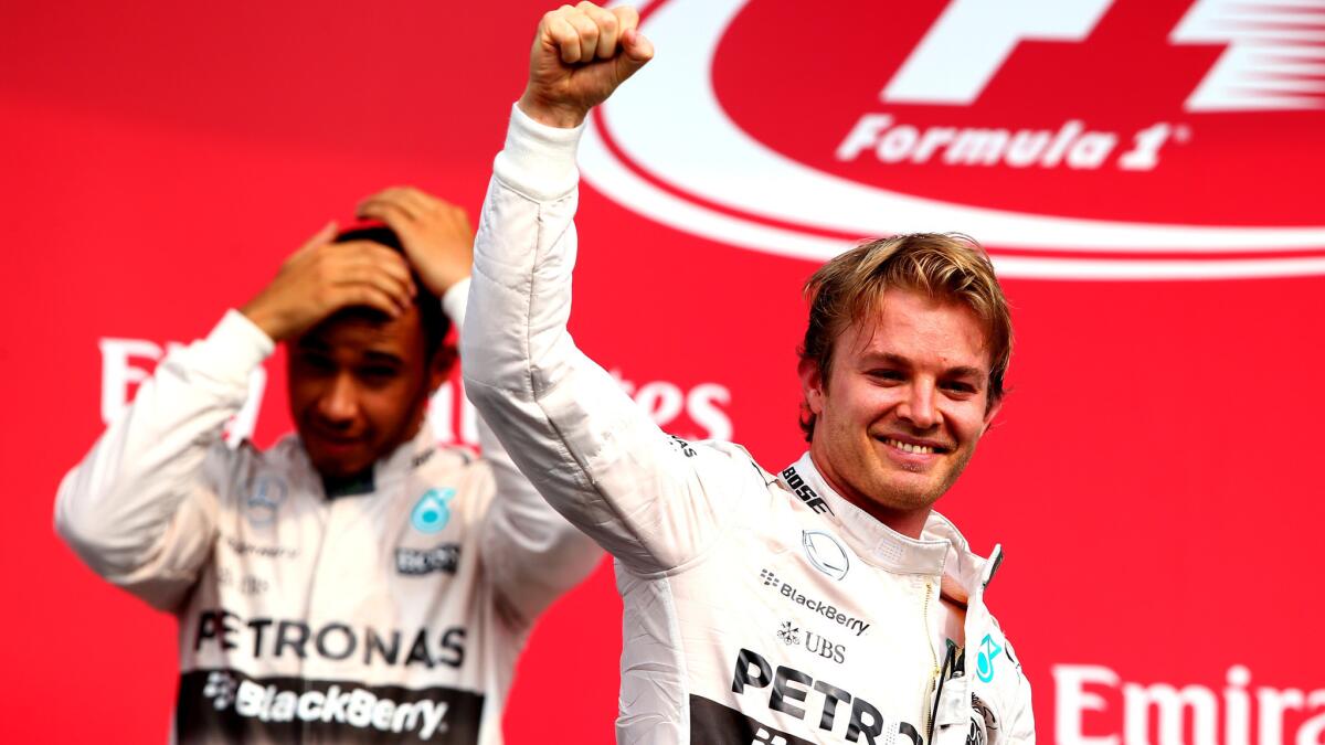 Formula One driver Nico Rosberg of Germany celebrates with Mercedes teammate Lewis Hamilton after winning the Grand Prix of Mexico on Sunday.