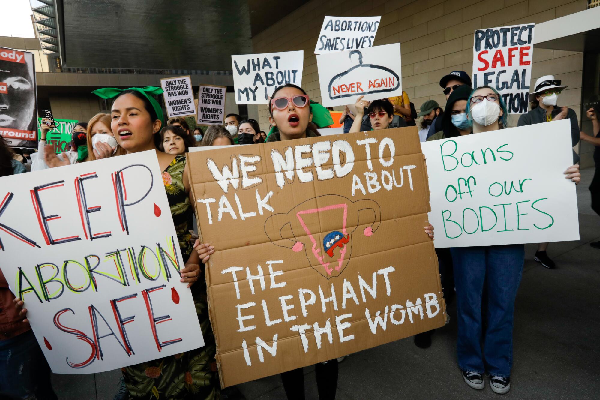 People hold signs in support of abortion rights